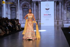actress hina khan gorgeous in a yellow lehenga choli doing a ramp walk