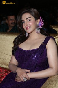 actress honey rose glamorous look in a purple dress at a function