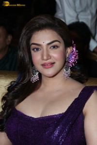 actress honey rose glamorous look in a purple dress at a function