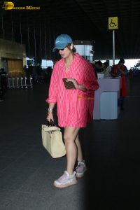 bollywood actress Huma Qureshi in a pink shirt at mumbai airport
