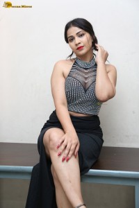 actress Inaya Sultana in a black top and matching skirt