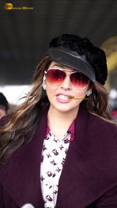 actress Isha Koppikar stylish in sunglasses and a long red coat