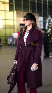 actress Isha Koppikar stylish in sunglasses and a long red coat