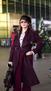 actress Isha Koppikar stylish in sunglasses and a long red coat