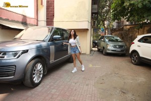 Actress Janhvi Kapoor in a white top and denim shorts