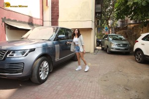 Actress Janhvi Kapoor in a white top and denim shorts