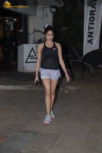 Bollywood Actress Janhvi Kapoor in a black top and silver shorts