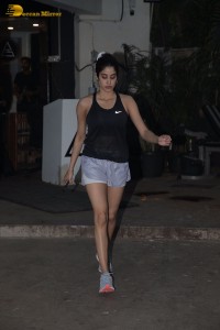 Bollywood Actress Janhvi Kapoor in a black top and silver shorts