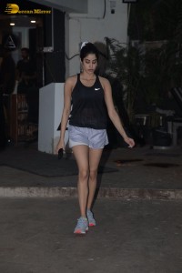 Bollywood Actress Janhvi Kapoor in a black top and silver shorts