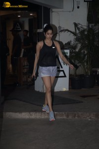 Bollywood Actress Janhvi Kapoor in a black top and silver shorts