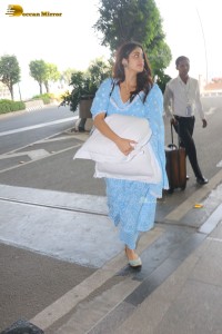 Actress Janhvi Kapoor in a blue salwar dress carrying a pillow at the Airport