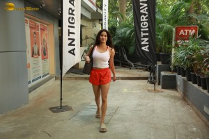 Bollywood Actress Janhvi Kapoor in white top and orange shorts