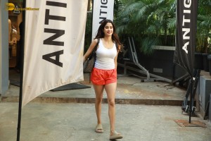 Bollywood Actress Janhvi Kapoor in white top and orange shorts