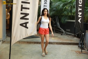Bollywood Actress Janhvi Kapoor in white top and orange shorts