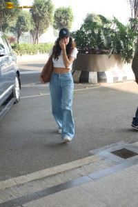 actress janhvi kapoor pretty in a white top and denim jeans at airport