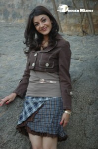 Actress Kajal Aggarwal in a brown coat and grey skirt