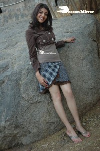 Actress Kajal Aggarwal in a brown coat and grey skirt