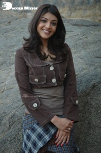 Actress Kajal Aggarwal in a brown coat and grey skirt