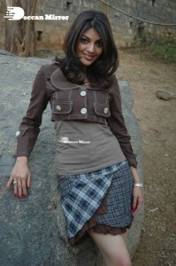 Actress Kajal Aggarwal in a brown coat and grey skirt