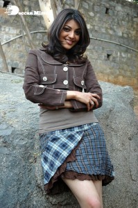 Actress Kajal Aggarwal in a brown coat and grey skirt