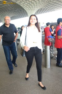 actress Kajal Aggarwal in a white top and black jeans