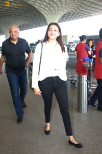actress Kajal Aggarwal in a white top and black jeans