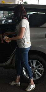 actress kajal agarwal classy and stylish in white top and denim jeans at airport