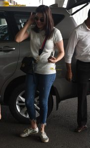 actress kajal agarwal classy and stylish in white top and denim jeans at airport