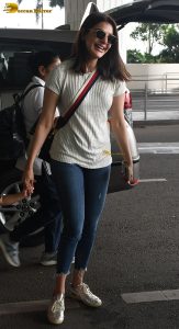 actress kajal agarwal classy and stylish in white top and denim jeans at airport