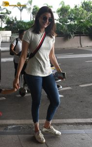 actress kajal agarwal classy and stylish in white top and denim jeans at airport