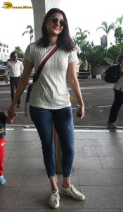 actress kajal agarwal classy and stylish in white top and denim jeans at airport