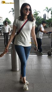 actress kajal agarwal classy and stylish in white top and denim jeans at airport