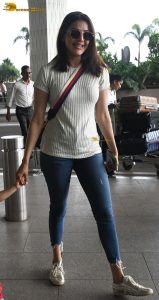 actress kajal agarwal classy and stylish in white top and denim jeans at airport