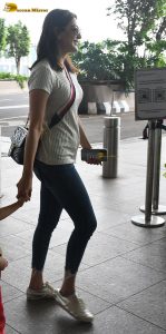 actress kajal agarwal classy and stylish in white top and denim jeans at airport