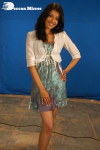 Actress Kajal Aggarwal in a green dress and a white coat