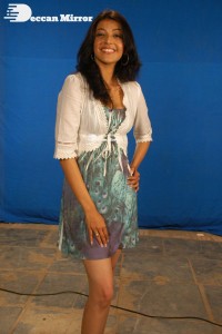 Actress Kajal Aggarwal in a green dress and a white coat