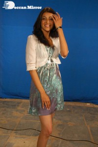 Actress Kajal Aggarwal in a green dress and a white coat