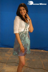 Actress Kajal Aggarwal in a green dress and a white coat