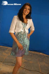 Actress Kajal Aggarwal in a green dress and a white coat