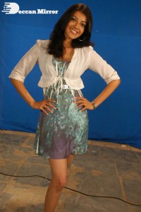 Actress Kajal Aggarwal in a green dress and a white coat