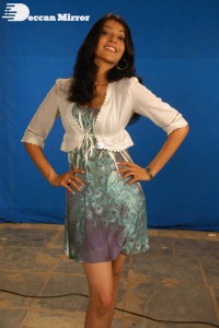 Actress Kajal Aggarwal in a green dress and a white coat