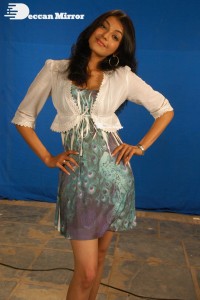 Actress Kajal Aggarwal in a green dress and a white coat