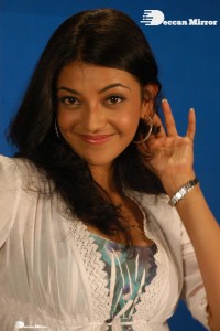 Actress Kajal Aggarwal in a green dress and a white coat