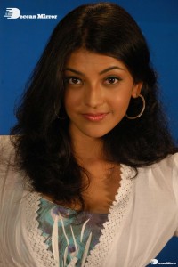 Actress Kajal Aggarwal in a green dress and a white coat