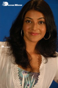 Actress Kajal Aggarwal in a green dress and a white coat