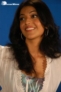 Actress Kajal Aggarwal in a green dress and a white coat