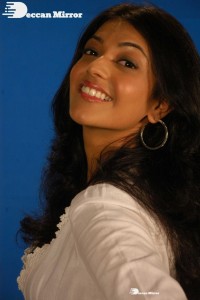 Actress Kajal Aggarwal in a green dress and a white coat