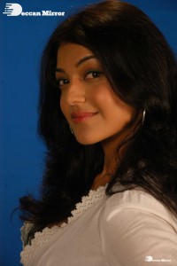 Actress Kajal Aggarwal in a green dress and a white coat