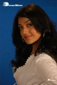 Actress Kajal Aggarwal in a green dress and a white coat