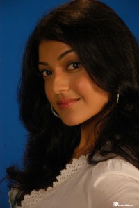 Actress Kajal Aggarwal in a green dress and a white coat